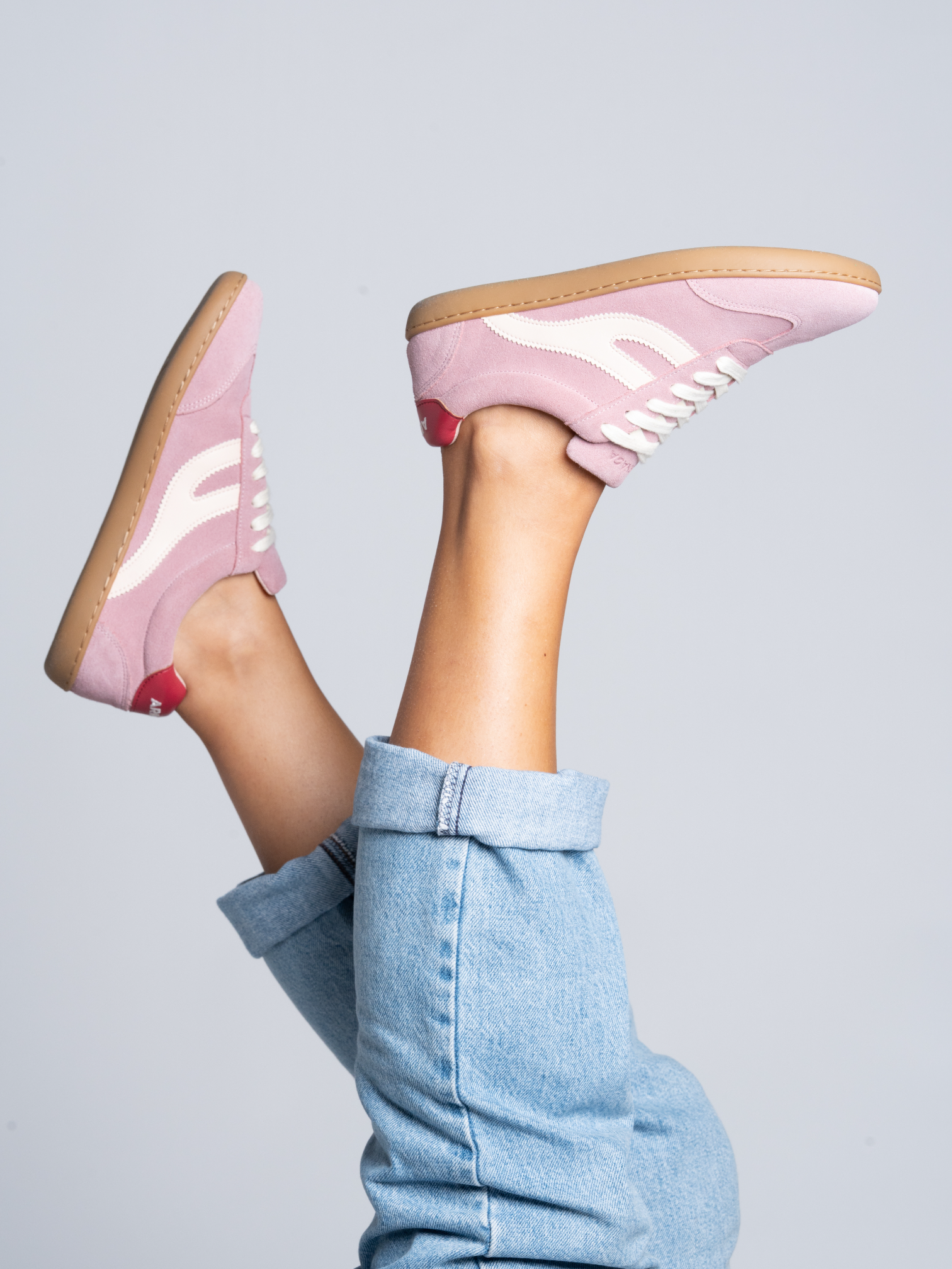 Persona con piernas levantadas mostrando zapatillas barefoot Atlantic Bloom rosa empolvado — ARNASA